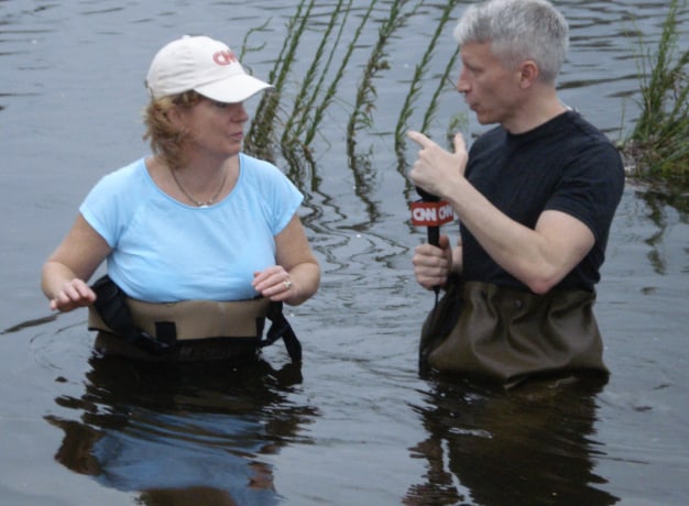 Rusty and Anderson Cooper wading in water